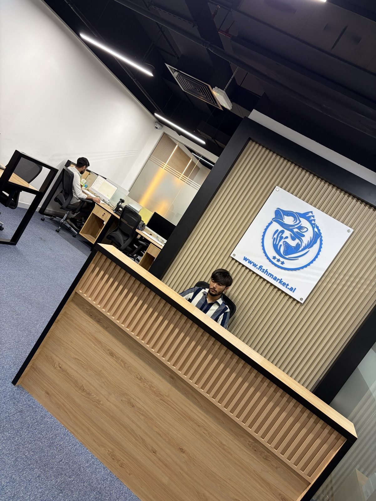 FishMarket.ai office reception and branded wall